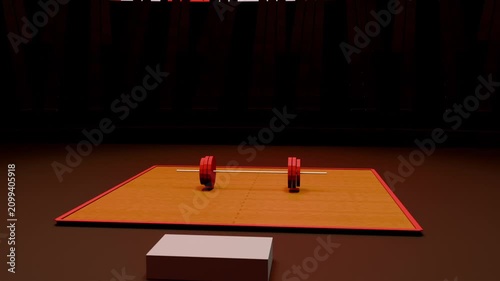 Pulling back camera moving upward and right across dim arena, revealing barbell on orange mat