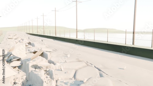 Cracking causing left shoulder to shed slabs along coastal causeway, with barrier, poles, water