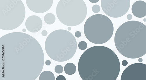 Abstract geometric background composed of overlapping round circles in modern shades of grey and blue on a pale background.