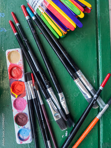 Watercolor paint palette and paintbrushes prepared for creative art class
