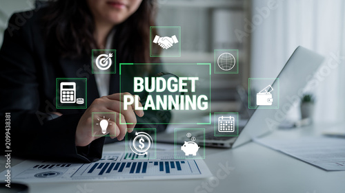 Принти на полотні Business Professional Engaged in Budget Planning with Charts, Technology Icons, and Financial Symbols in an Office Setting Fluxor