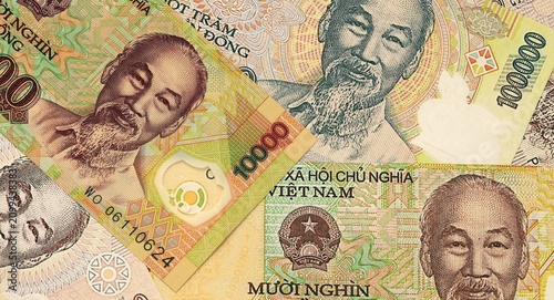 Vietnamese dong money bills in pile on table. Vietnam VND currency cash close up