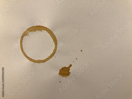 Coffee Ring Stain On White Paper, Brown Circular Beverage Mark, Small Coffee Spill, Minimal Rustic Texture, Natural Stained Surface, Vintage Grunge Background Design