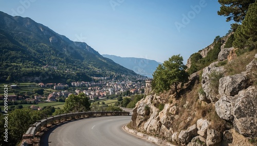 Scenic Road Winding Through Mountains Above a Small Town in Italy on a Clear ...