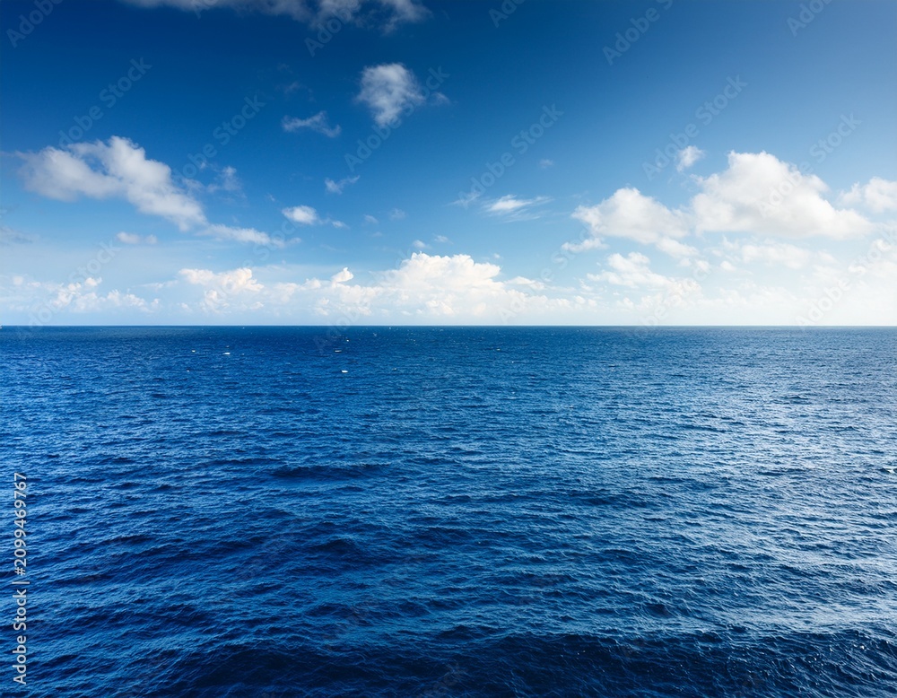 Fototapeta premium a vast horizon of the ocean with a few light clouds