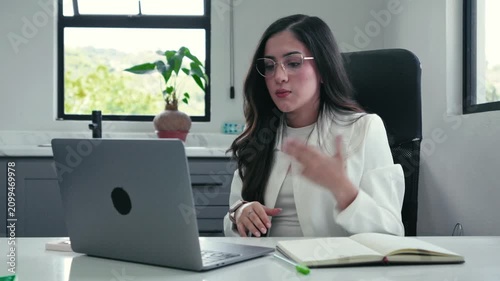 Professional businesswoman leading a video conference call on laptop