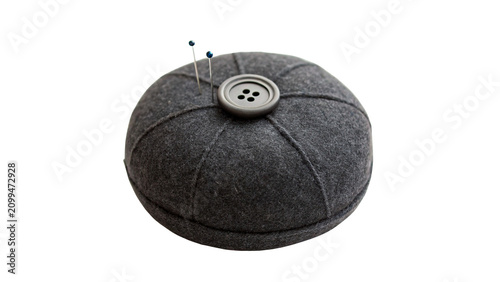 Foto Round dark gray fabric pincushion with central button isolated on transparent ba