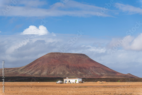 Fuerteventura island Canary islands Spain. Corralejo Natural Park features beaches with strong winds and dunes, is home to endangered wildlife species, and the Red Mountain, a volcano 