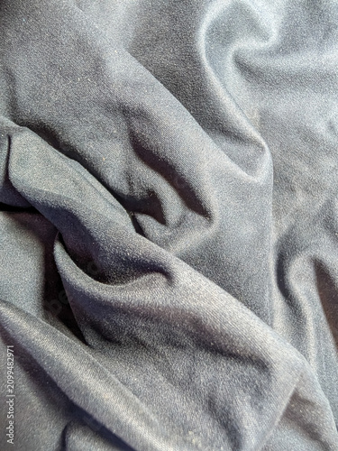 Soft Gray Fabric with Elegant Draped Folds Forming a Modern Luxury Textile Background