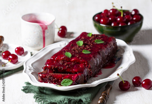 Obraz na płótnie Chocolate Cherry Loaf Cake with Cherry Sauce and Fresh Mint Garnish