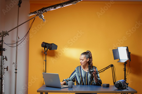 Content creator records professional studio content for subscribers while explaining lighting equipment, modifier use and practical studio production for online video subscribers.