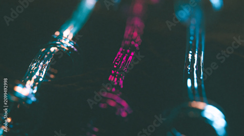 Abstract closeup of glowing fiber optic cables with blue and pink light