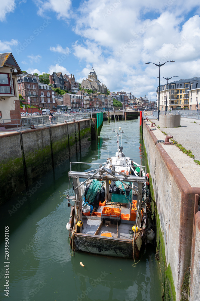 Fototapeta premium Views of Le Treport, seaside resort in Normandy, France, with white cliffs along English Channel, fishing industry and old buildings, travel destination in France