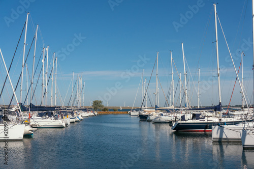 Marina, yachts at piers, a ‘palisade’ of masts. Stellendam, (village), Netherlands.