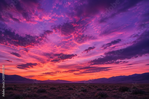 Vibrant Pink and Purple Sunset Sky over an Open Landscape