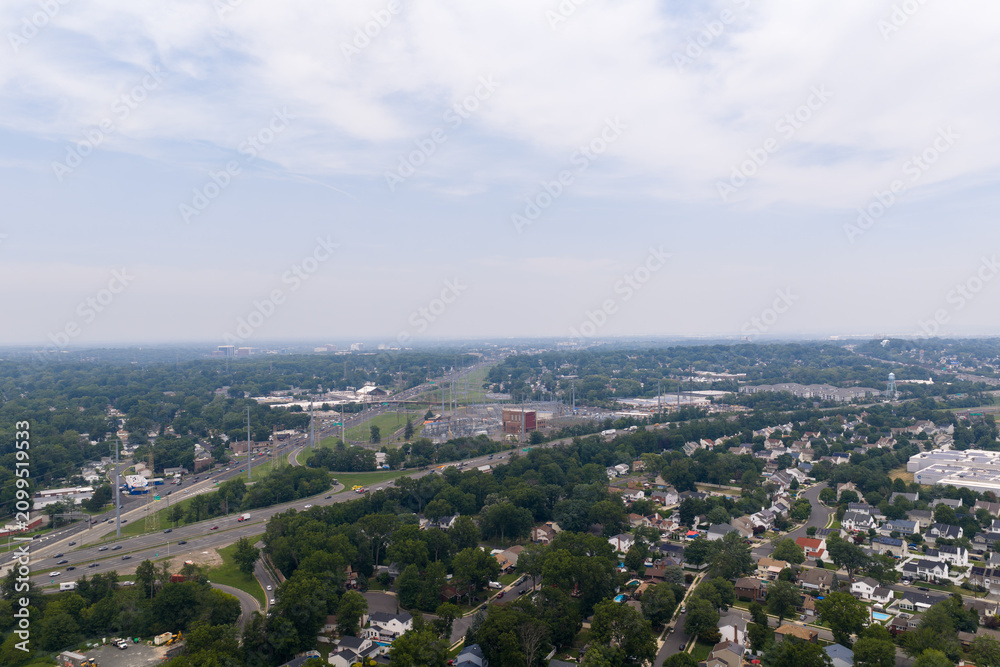 Fototapeta premium Aerial view of suburban landscape with highway traffic