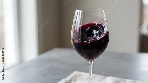 Swirling Red Wine: A close-up of dark red wine swirling elegantly in a clear wine glass, capturing the rich color and movement of the liquid.