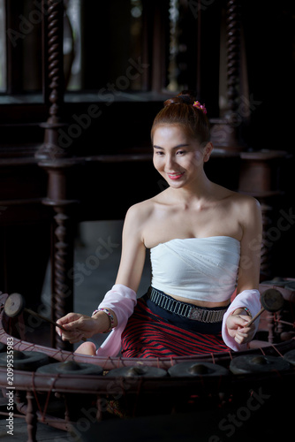 Beautiful Chiang Mai Woman in Traditional Lanna Dress Playing Khong Wong a traditional Thai Kong Circle Instrument