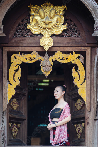 Beautiful Chiang Mai Woman in Traditional Lanna Dress Relaxing in an Ancient Teak Wooden House