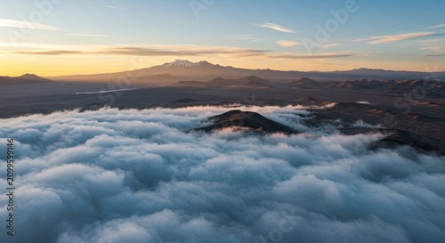 Mountain range above the clouds at sunrise.
