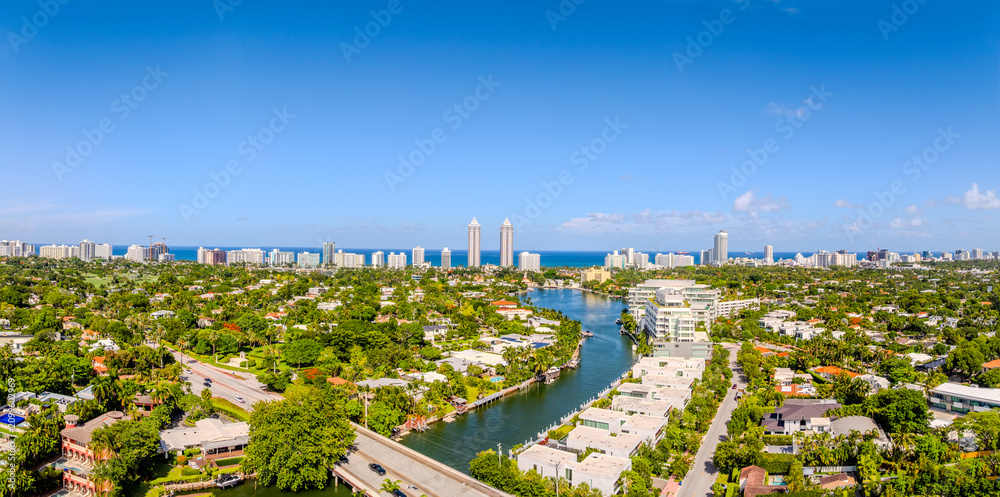 Obraz premium Aerial Panoramic View of Surfside Miami Florida Luxury Waterfront Real Estate with Canal Leading to Atlantic Ocean