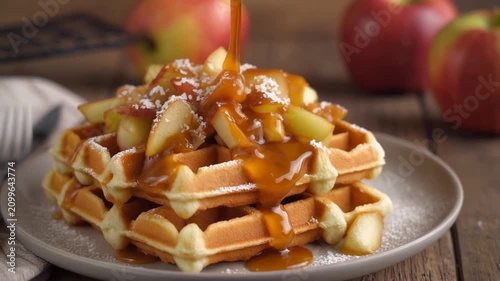 Caramel Sauce Pouring over Apple Topped Belgian Waffles