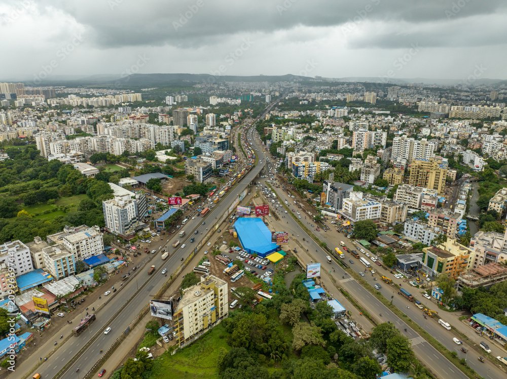 Fototapeta premium Aerial view of expressway interchange and urban landscape in Pune 