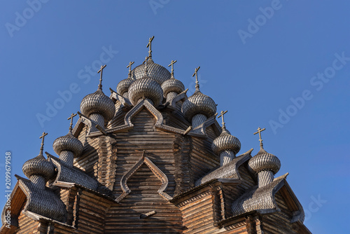 Tableau sur toile Wooden multi domed church top against blue sky