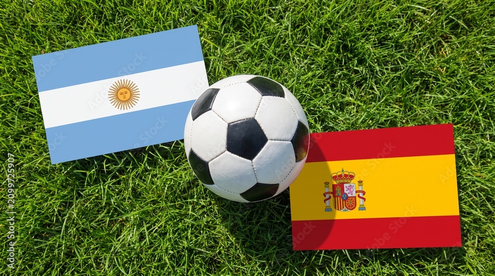 Fototapeta premium Argentina vs Spain Soccer Match Concept with Flags on Green Grass
