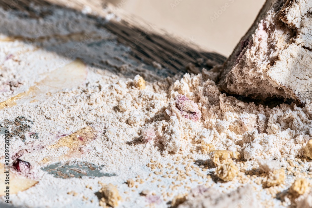 Fototapeta premium Flour and bread crumbs on a weathered oak surface with soft fruit stains for Rosh Hashanah food editorials and seasonal autumn backgrounds