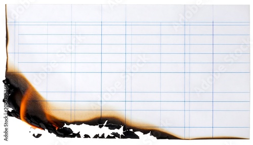 Burning edge of a white lined ledger paper sheet with bright orange flames and glowing charcoal embers