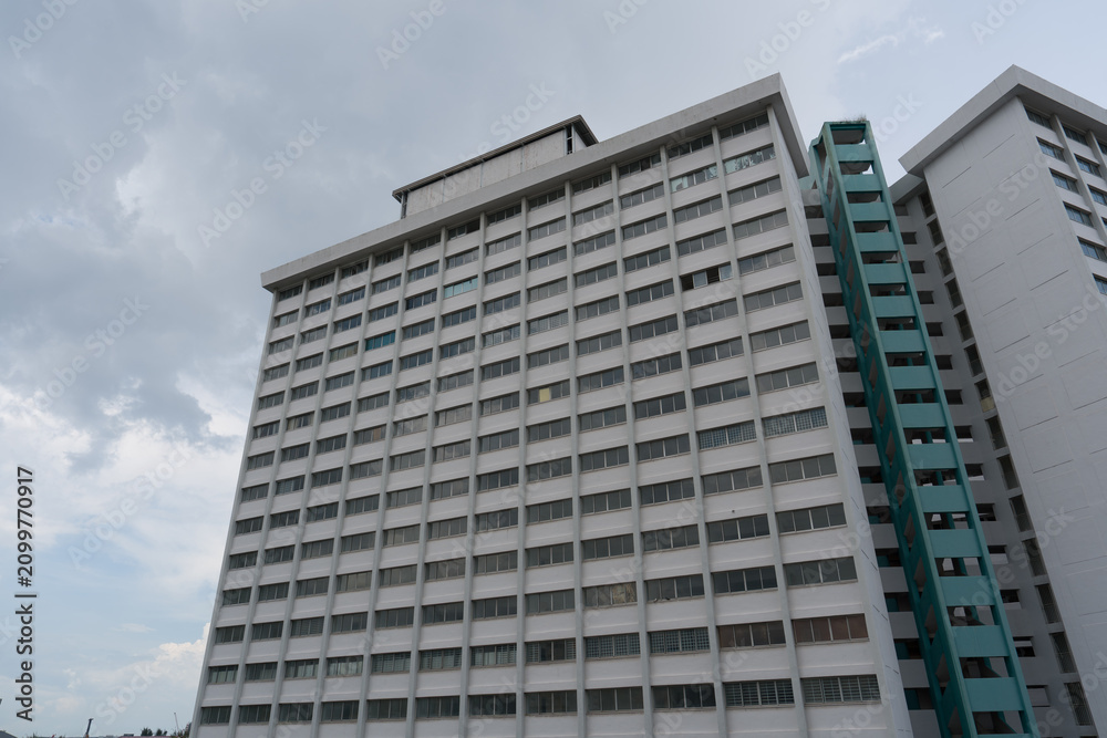 Fototapeta premium Tall building with many windows and balconies
