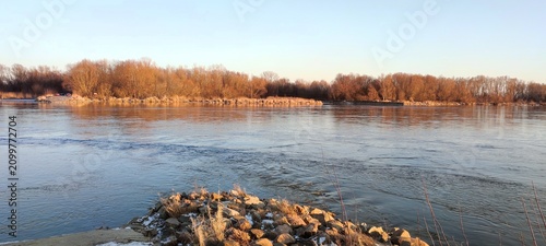 Принти на полотні Scenic View of Vistula River with Autumn Trees and Clear Sky