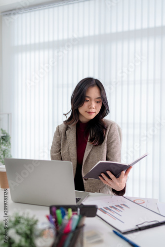 Portrait of confident Asian businesswoman working in office