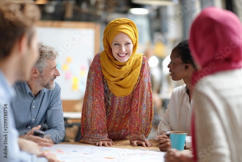 Diverse Team Collaborating on a Project Plan in Office Meeting