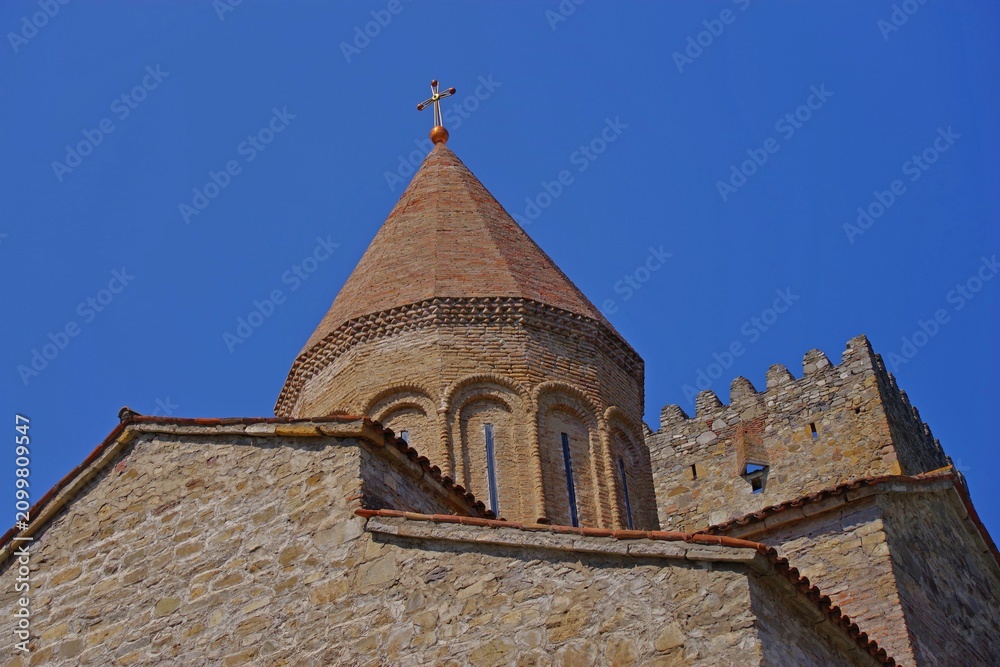 Obraz premium Ancient Ananuri fortress church dome and stone tower with sky copy space