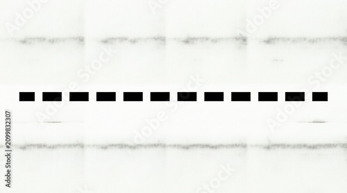 Black dashed line on a textured paper surface