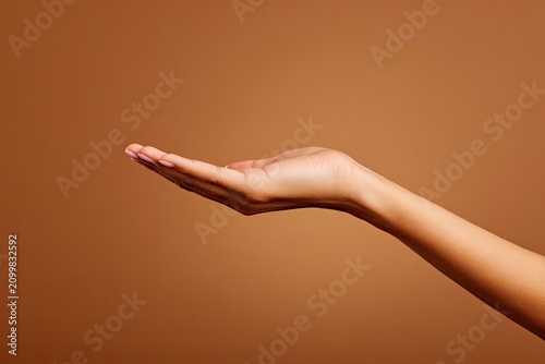 Woman Hand Open Palm Offering Product Space Brown Background