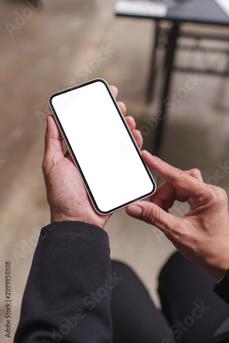 Person holding smartphone with blank white screen mockup