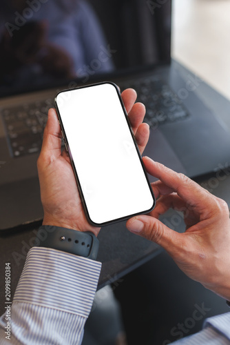 Person holding smartphone with white screen for mockup