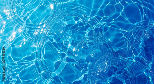 Crystal Clear Blue Water Ripples on a Swimming Pool Surface with Sunlight Glints