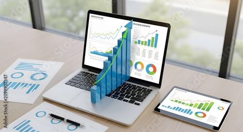3D business growth bar chart and graphs on laptop screen and tablet financial data analysis