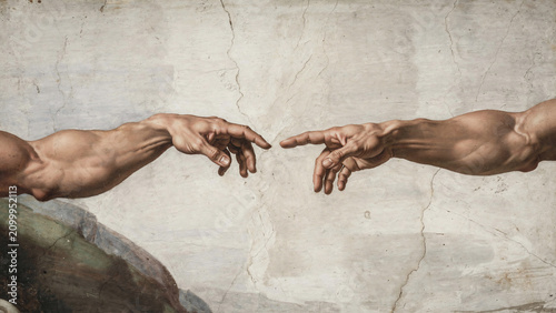 Close-up of two hands reaching, almost touching on a textured background, concept for connection, creation and divine inspiration