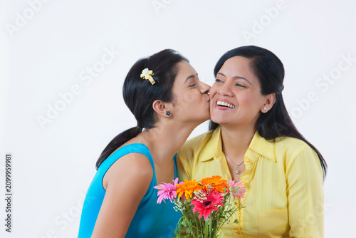 фотографія Girl kissing mother on cheek
