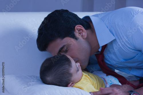 Father kissing baby