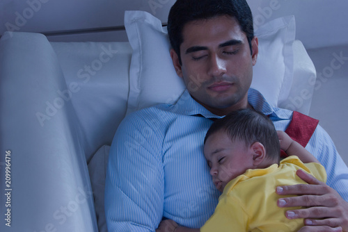 Father and baby sleeping