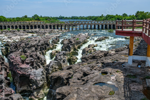 A high-angle shot of the naturally formed basalt rock potholes, locally known as Ranjan Khalge, carved over centuries by the Kukadi River in Nighoj, Ahmednagar district, Maharashtra, India.