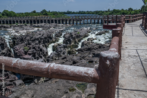 A high-angle shot of the naturally formed basalt rock potholes, locally known as Ranjan Khalge, carved over centuries by the Kukadi River in Nighoj, Ahmednagar district, Maharashtra, India.