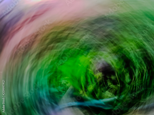 Foto Abstract intentional camera movement motion blur green and purple vortex backgro
