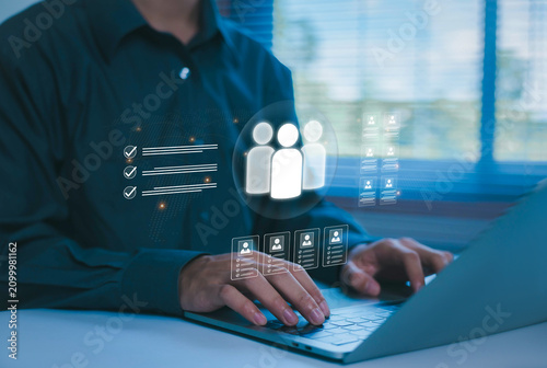 Принти на полотні Businessman using a laptop with a virtual human resources interface, representing recruitment, employee management, talent acquisition, workforce planning, digital HR technology, and team management